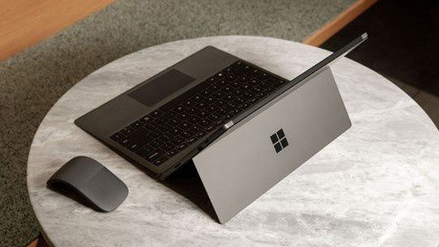 Surface Pro 7  in Matte Black with Surface Arc Mouse on a small table